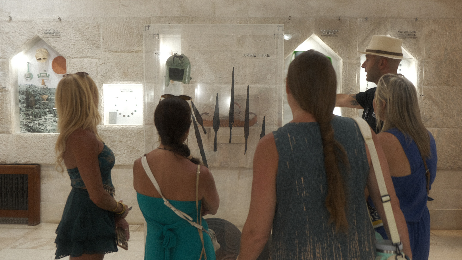 A local guide showing travellers ancient artifacts in an Albanian museum